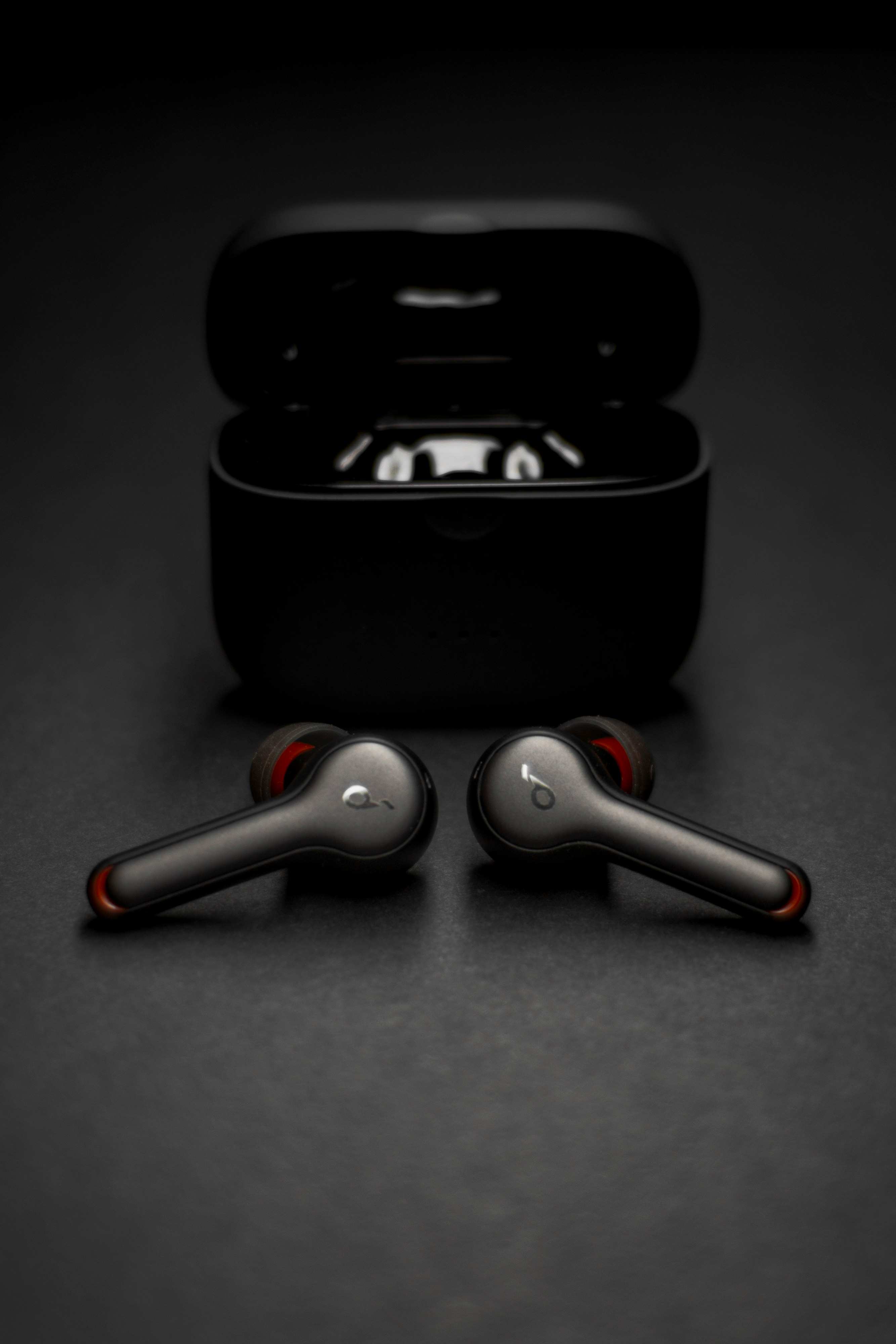 black and silver wireless earbuds